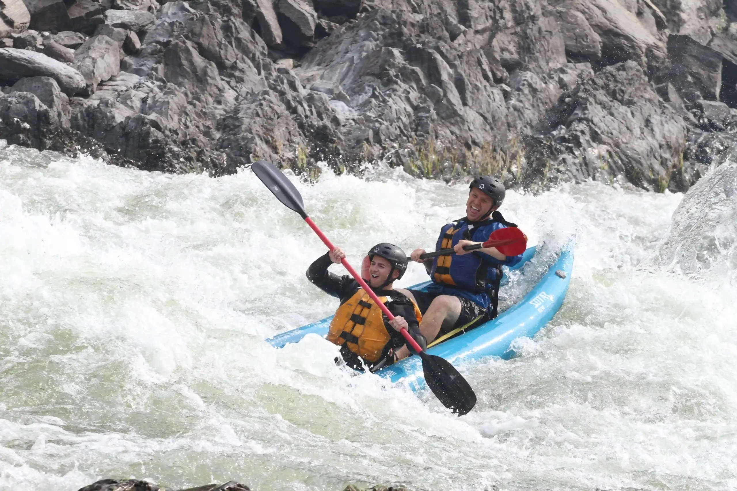 two people enjoying Kayaking with waves