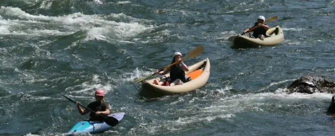 three people enjoying kayaking